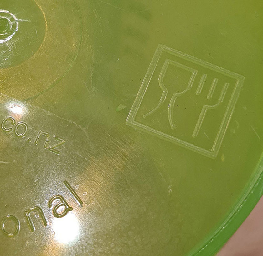 green underside of plastic container with food safe logo