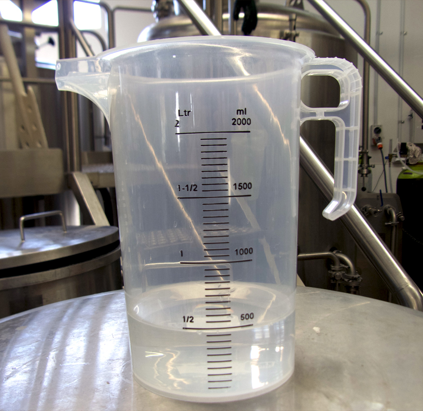 a two litre plastic measuring jug in an industrial setting